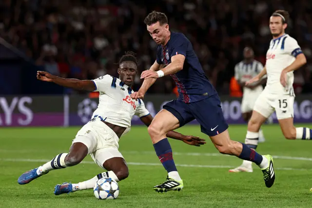 Atalanta's Ivorian defender #03 Odilon Kossounou (L) and Paris Saint-Germain's Spanish midfielder #08 Fabian Ruiz (R) fight for the ball during the UEFA Champions League first round day 1 football match between Paris Saint-Germain (FRA) and Atalanta (ITA) at the Parc des Princes stadium