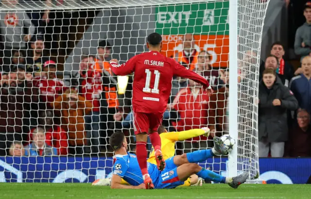 Liverpool's Mohamed Salah shoots at goal and hits the post