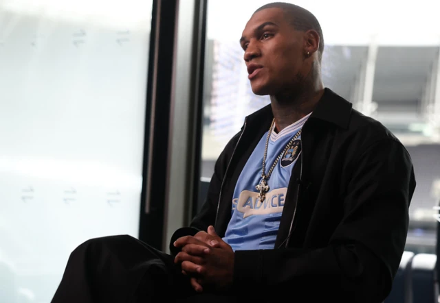 Conor Benn wears a Manchester City top