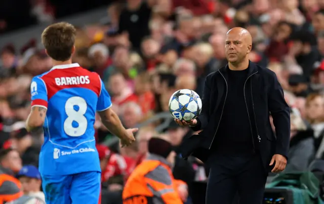 Liverpool manager Arne Slot gives the ball to Atletico Madrid's Pablo Barrios