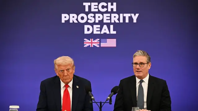 Donald Trump and Keir Starmer sitting in front of a blue wall marked with the writing Tech Prosperity Deal, a US and UK flag underneath