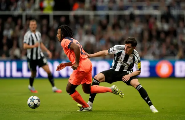 Newcastle United's Tino Livramento (right) and Barcelona's Jules Kounde (left) battle for the ball during the UEFA Champions League league phase match at St. James' Park, Newcastle.