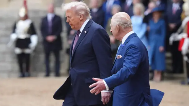 Trump walking slightly ahead of King Charles at Windsor Castle, as Charles gestures him to do so