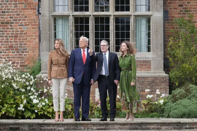 Keir Starmer pointing upwards as he stands next to his wife, Victoria, and Donald and Melania Trump outside Chequers