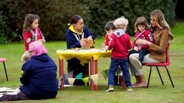 US first lady Melania Trump interacts with children during her tour to the Frogmore Gardens with Britain's Catherine, Princess of Wales, in Windsor