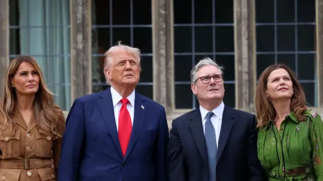 Melania and Donald Trump, stood next to Starmer and his wife, they're looking up to the sky.