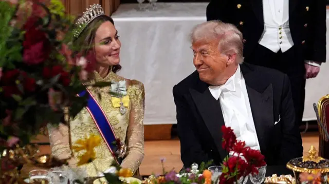 US President Donald Trump smiles at Britain's Catherine, Princess of Wales during a State Banquet at Windsor Castle