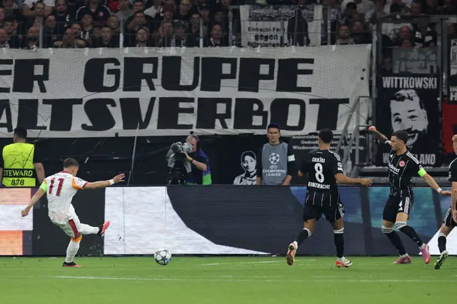 Galatasaray's Turkish forward #11 Yunus Akgun (L) kicks the ball to score the 0-1 goal during the UEFA Champions League league phase day 1 football match between Eintracht Frankfurt and Galatasaray in Frankfurt