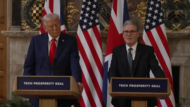 Starmer speaks at the lectern as Trump looks down