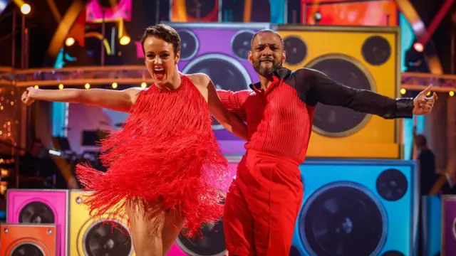 JB Gill and Lauren Oakley dancing the salsa in red outfits on the Strictly dance floor