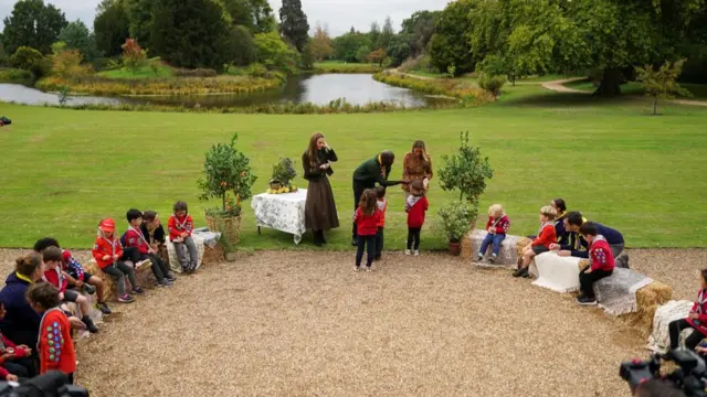 US first lady Melania Trump and Britain's Catherine, Princess of Wales interact with children, who are a part of the Scouts division "Squirrels", as they tour Frogmore Gardens in Windsor