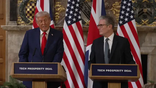 Trump speaks as Starmer looks left towards him