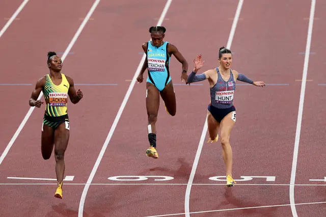 First placed Shericka Jackson of Team Jamaica (L), fourth placed Anthonique Strachan of Team Bahamas (C) and second placed Amy Hunt of Team Great Britain