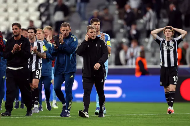 Eddie Howe, Manager of Newcastle United, looks dejected as he is spoken to by Graeme Jones, Coach of Newcastle United, after the team's defeat in the UEFA Champions League 2025/26 League Phase MD1 match between Newcastle United FC and FC Barcelona at St James' Park on September 18, 2025 in Newcastle upon Tyne, England.