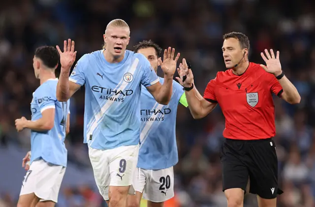Erling Haaland of Manchester City interacts with Referee Felix Zwayer
