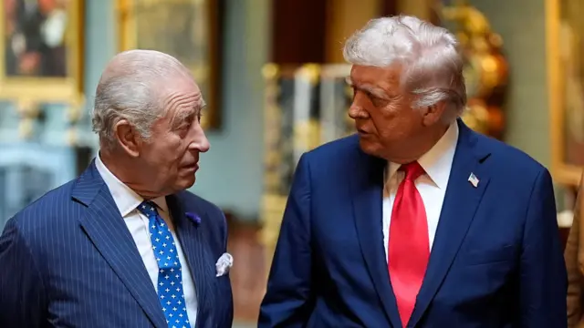 King Charles and President Trump face each other in conversation.