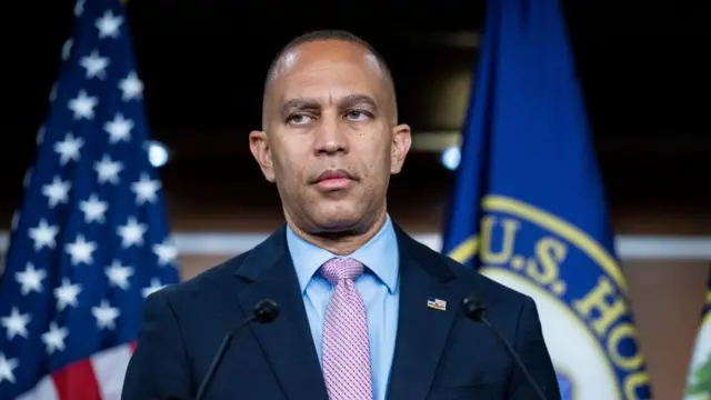 A file photo of Jeffries - he is standing at a podium in front of the US flag