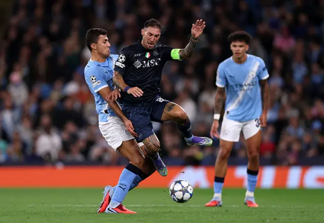 Matteo Politano of Napoli is challenged by Rodri of Manchester City during the UEFA Champions League 2025/26 League Phase MD1 match between Manchester City and SSC Napoli at City of Manchester Stadium on September 18, 2025 in Manchester, England.
