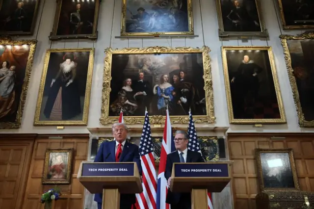 Trump and Starmer at the lecterns, and the camera is tilting up to show all the portraits on the tall wall behind them.