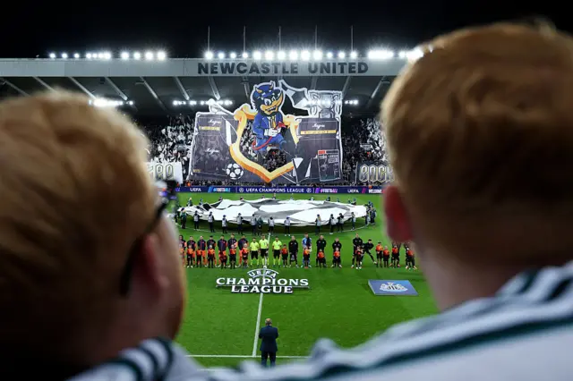 A general view as FC Barcelona and Newcastle United players line up on the pitch whilst a tifo is displayed prior to the UEFA Champions League 2025/26 League Phase MD1 match between Newcastle United FC and FC Barcelona at St James' Park on September 18, 2025 in Newcastle upon Tyne, England.