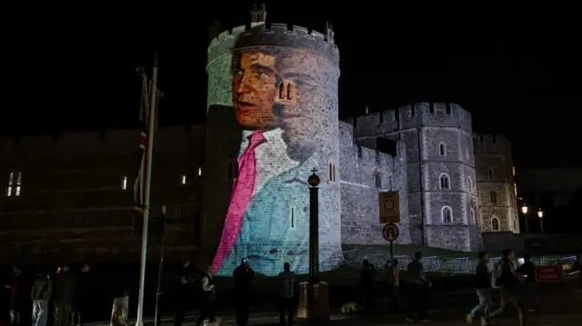 A picture of Donald Trump and Jeffrey Epstein from the 1990s projected on a tower of Windsor Castle