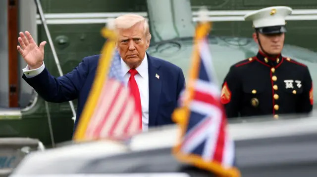 President Trump waves as he arrives on the grounds of Chequers.