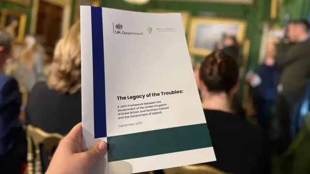 A copy of the report being held up