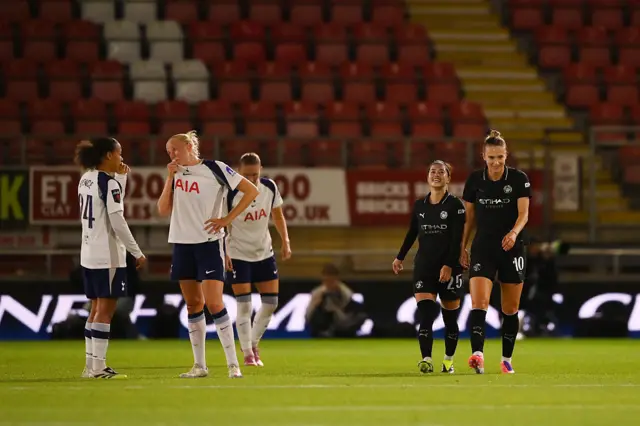 Tottenham's players (left) look dejected as Man City's players (right) look happy.