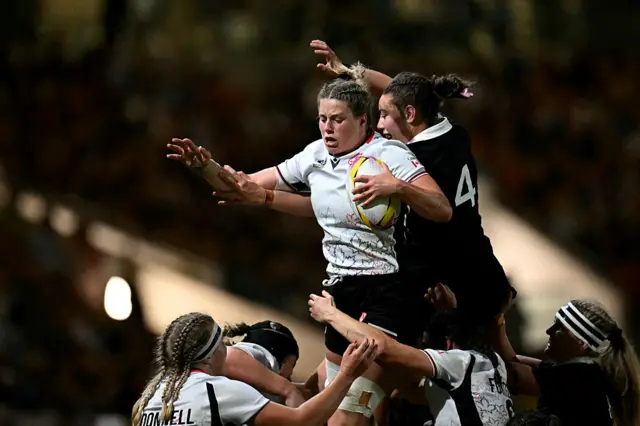 Sophie de Goede leaps for the ball