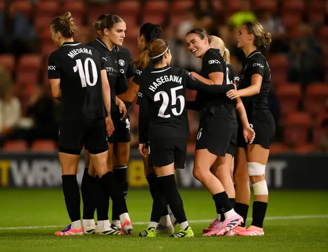 Manchester City celebrate Grace Clinton's goal against Tottenham.
