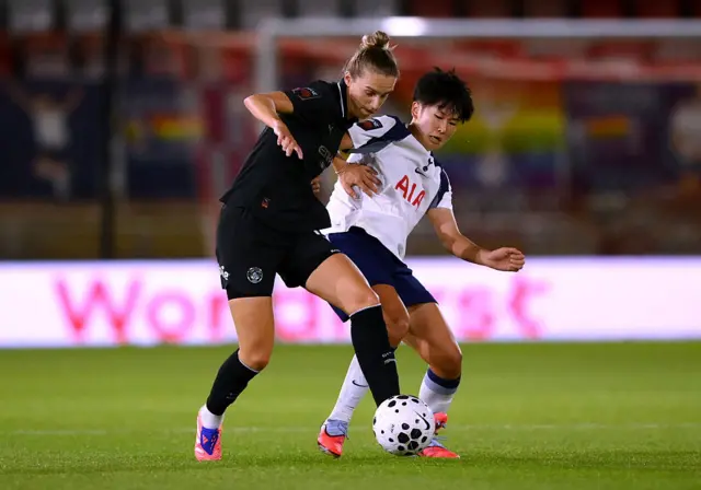 Vivianne Miedema competes for the ball with Toko Koga