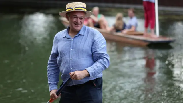 Liberal Democrat leader Sir Ed Davey punts along the river Cam during his visit to Cambridge, to highlight how ongoing river pollution and the lack of investment in the Cam lock system could lead to catastrophic failures of the sluices and weirs