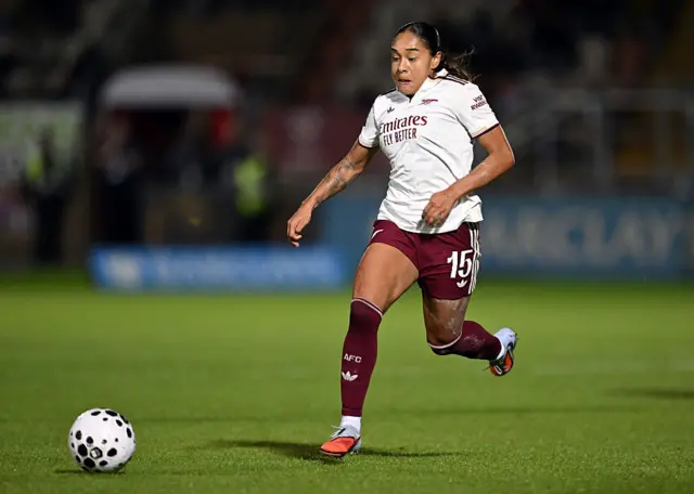 Olivia Smith running with the ball for Arsenal