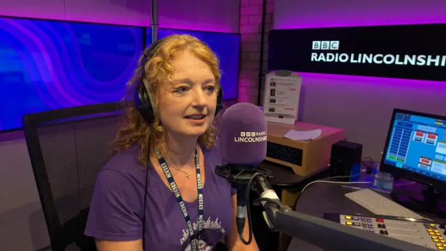Frances Finn pictured in front of a microphone in a studio