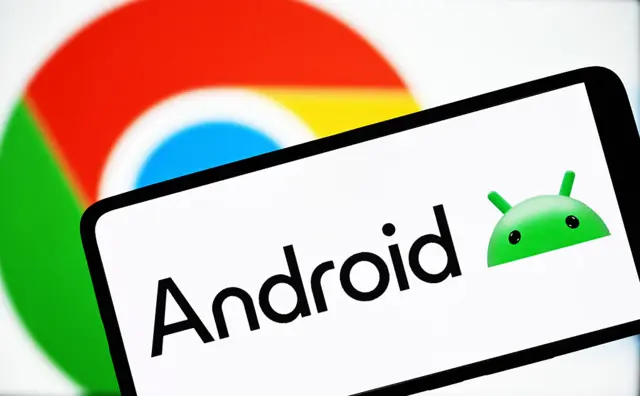 In this photo illustration, an Android logo is seen on a smartphone and a ChromeOS logo in the background.
