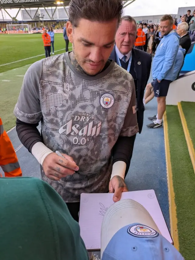 Ederson signing autographs at the club's open training session