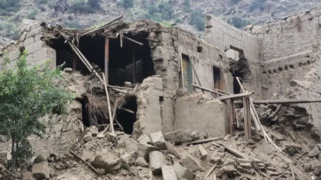 A damaged house with a missing wall