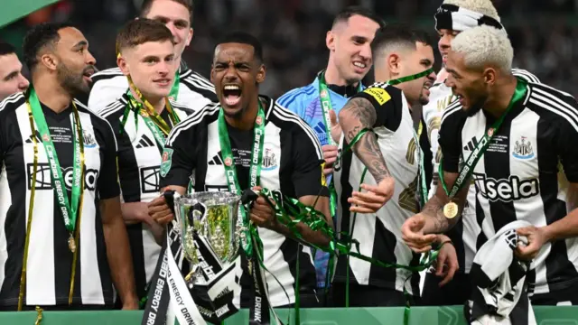 Alexander Isak celebrates with EFL Cup