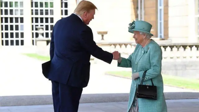 Queen Elizabeth II greets President Trump at Buckingham Palace. The pair are shaking hands