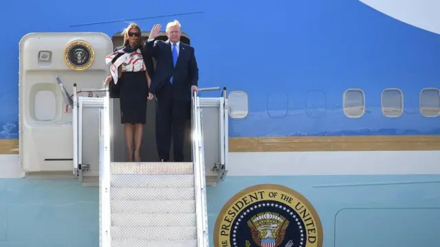 Donald Trump and Melania Trump on the steps of Air Force One, Trump is waving to the camera