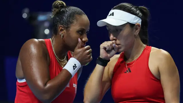 Taylor Townsend (L) and Jessica Pegula prepare to play a point