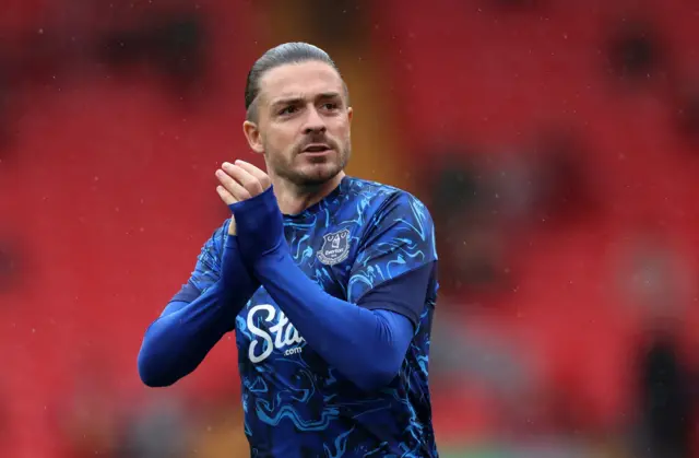 Grealish claps the fans as he goes out to warm up
