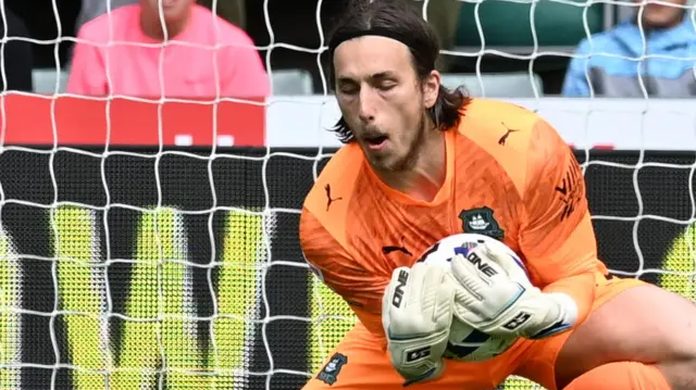 Plymouth goalkeeper Luca Ashby-Hammond making a save