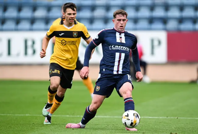 Livingston's Macaulay Tait and Dundee's Finlay Robertson in action