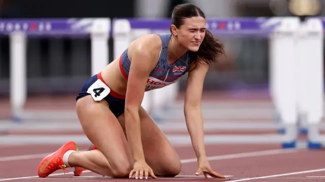 Abigail Pawlett on her knees after falling in the 100m hurdles