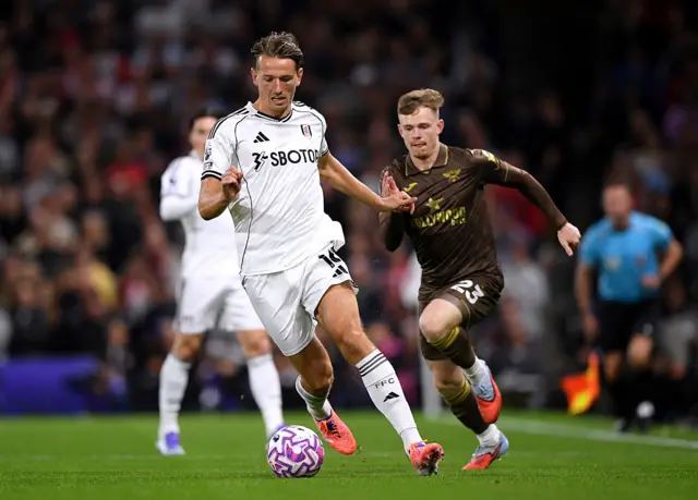 Sander Berge and Keane Lewis-Potter battle for the ball
