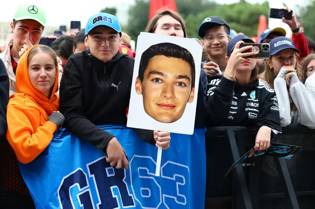 Fans hold up signs for George Russell in Baku
