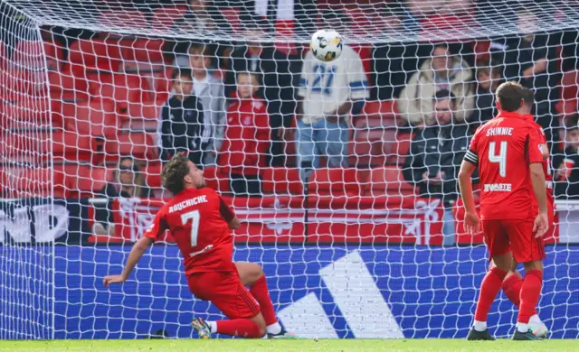 Adil Aouchiche clears the ball off the line for Aberdeen