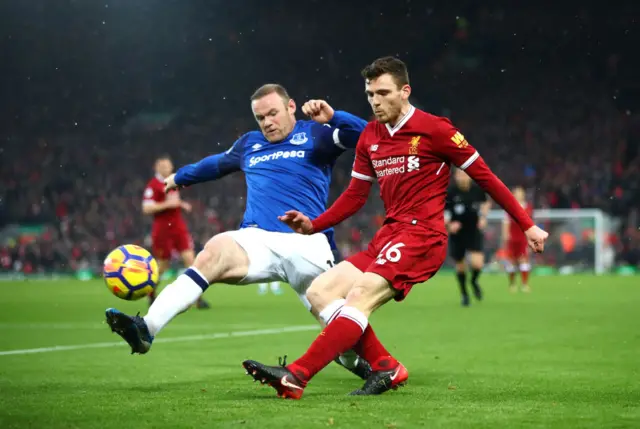 Wayne Rooney of Everton and Andy Robertson of Liverpool battle for possession