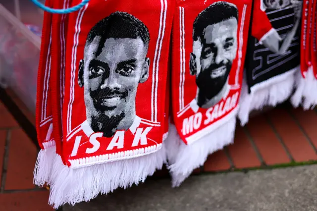 Scarves with Isak and Salah's faces on them outside Anfield